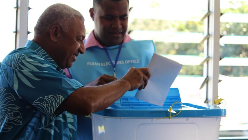 Fiji's interim prime minister Frank Bainimarama casts his vote in the national election