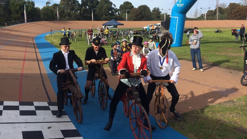 Charlie Farren (centre) begins a race of replica vintage cycles around the Brunswick velodrome.