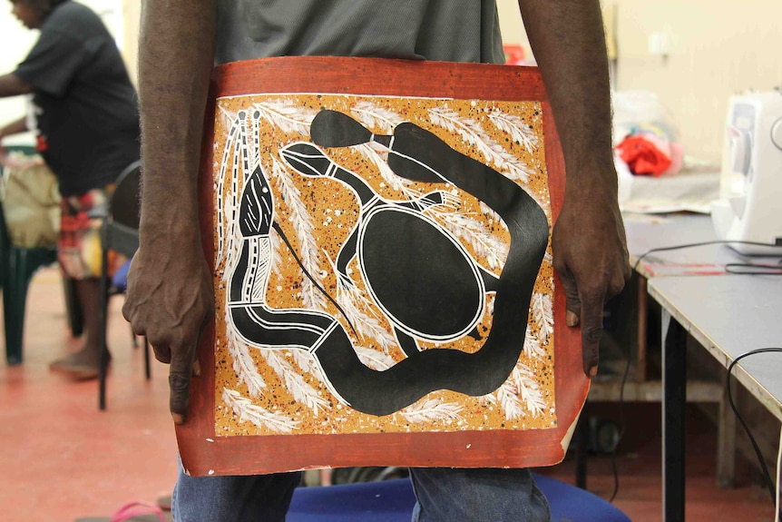 A man's hands holding art