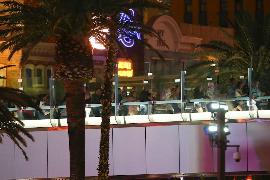 Hundreds of people run across a bridge connecting hotels in Las Vegas.