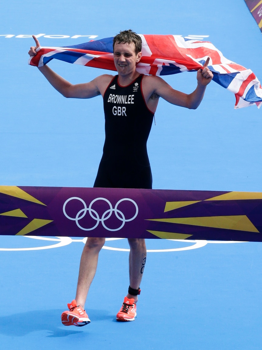 Flying the flag for Great Britain ... Alistair Browlee crosses the finish line for gold.