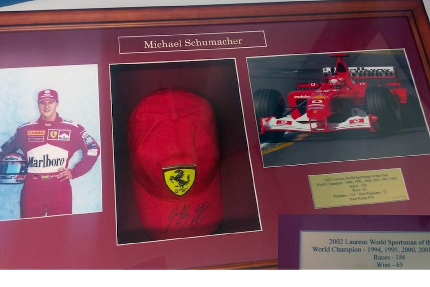 Photographs and memorabilia of German racing driver Michael Schumacher including his cap