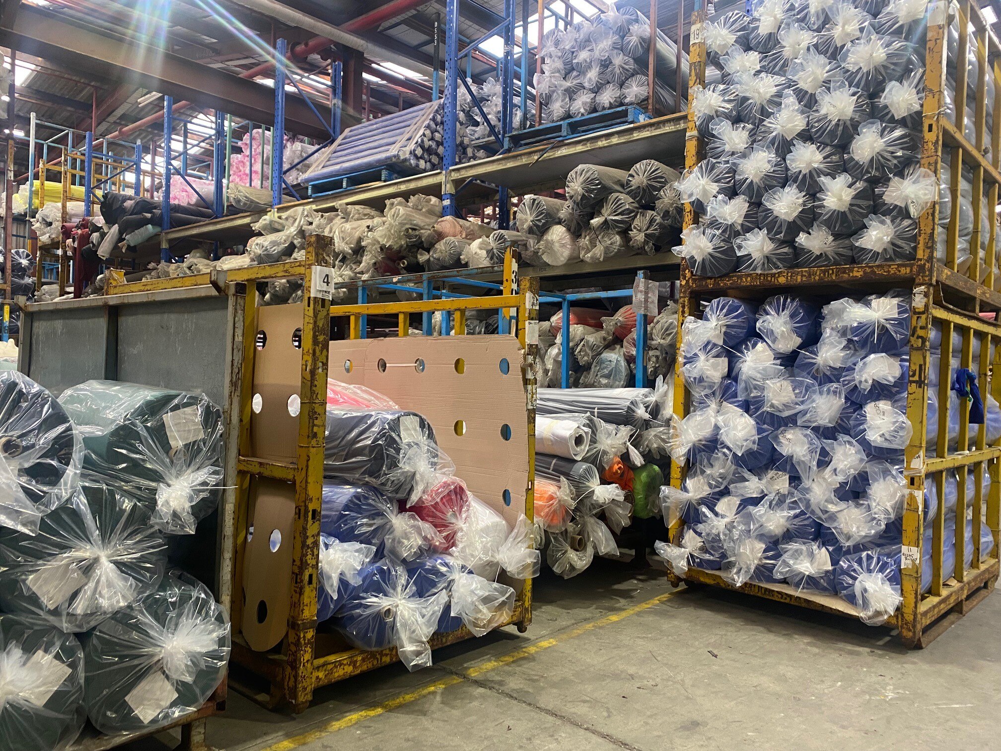 Textiles pile up in a factory.