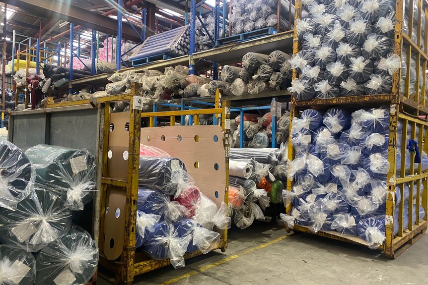 Textiles pile up in a factory.