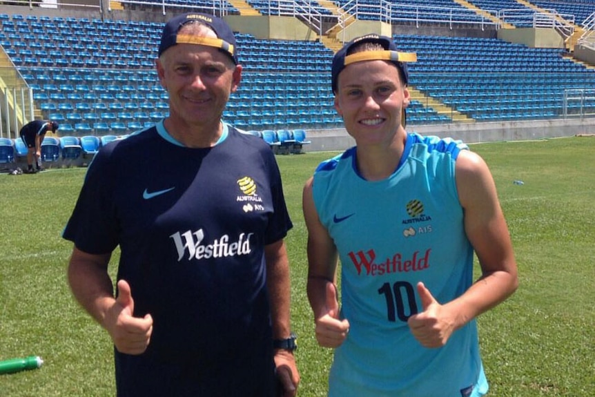 Emily Van Egmond with her dad Gary at training. Both are giving the thumbs up sign.