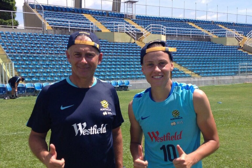 Emily Van Egmond with her dad Gary at training. Both are giving the thumbs up sign.