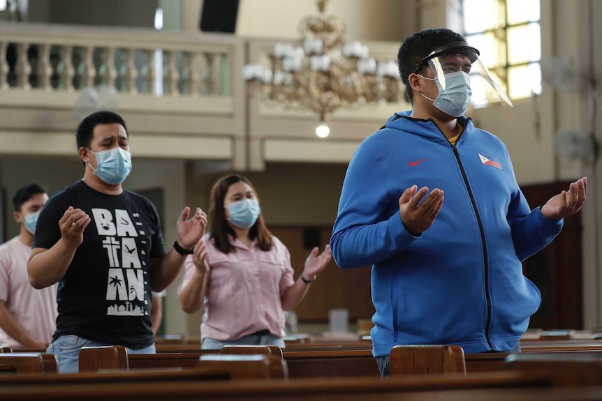 Parishioners wear face masks during Mass at a church in Quezon city, Philippines.
