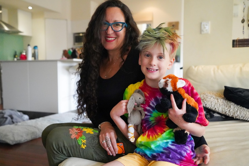 Jenny and her youngest child sitting on the sofa. 