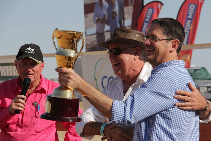 Andrew Saunders from Mount Isa celebrates his horse Iron Meteorite taking out the Birdsville Cup