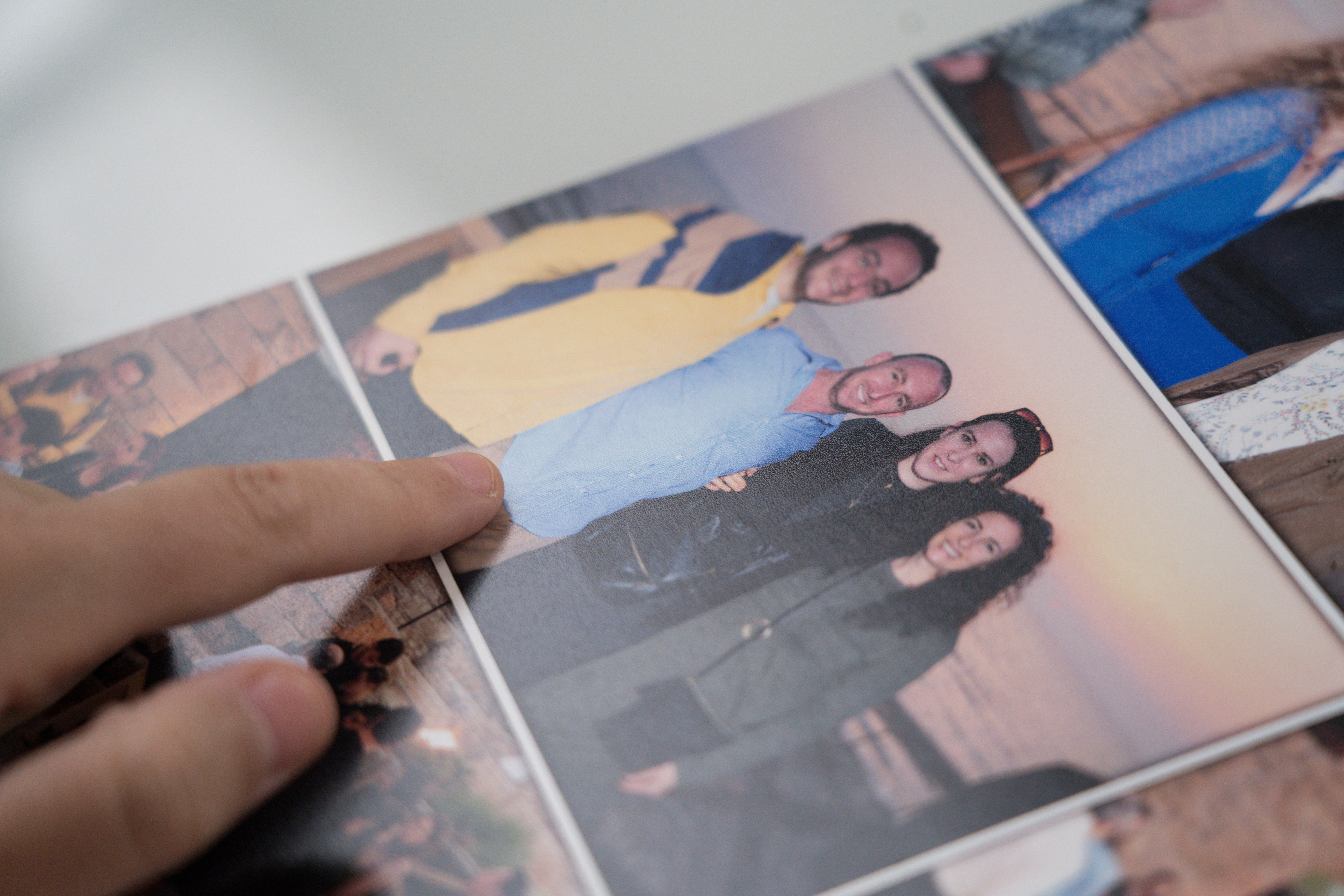 A hand pointing to a photo album