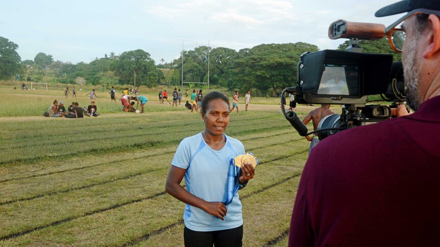 Olympian Sharon Firisua speaking on camera about women's participating in sport