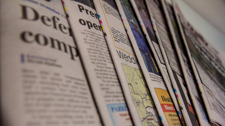 Close up image of a fanned selection of newspapers