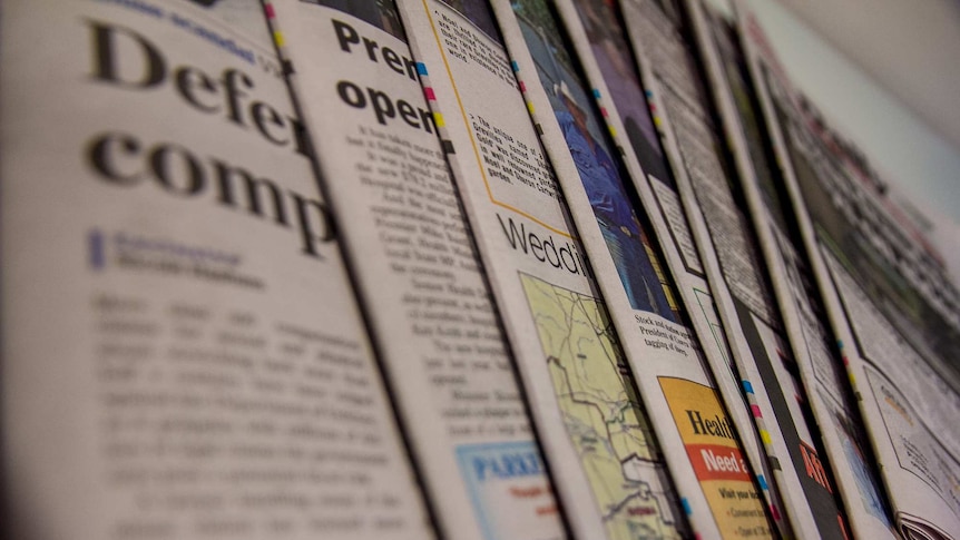 Close up image of a fanned selection of newspapers