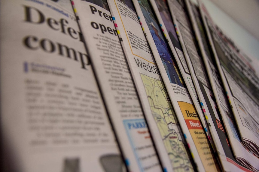 Close up image of a fanned selection of newspapers