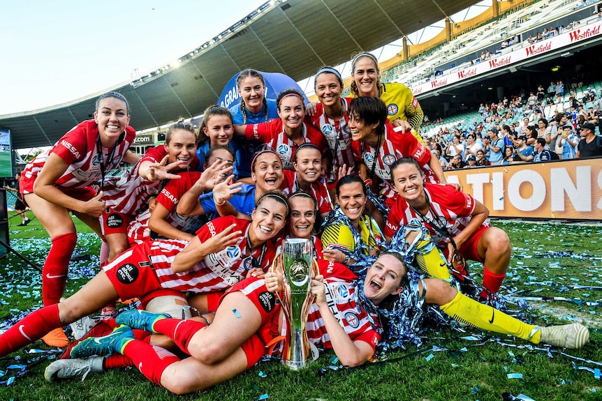 Melbourne City celebrates with the W-League trophy on the field at the Sydney Football Stadium.