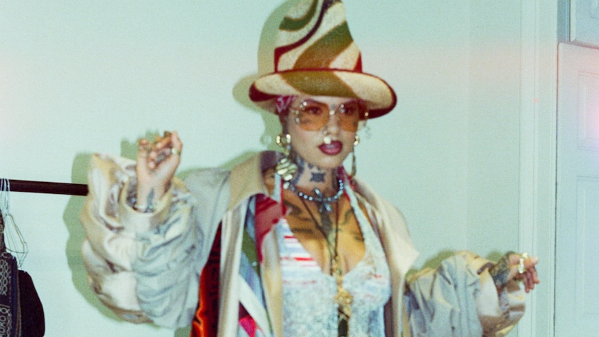 South London singer Greentea Peng wears a big hat and a flowing vintage coat with lot of patterns
