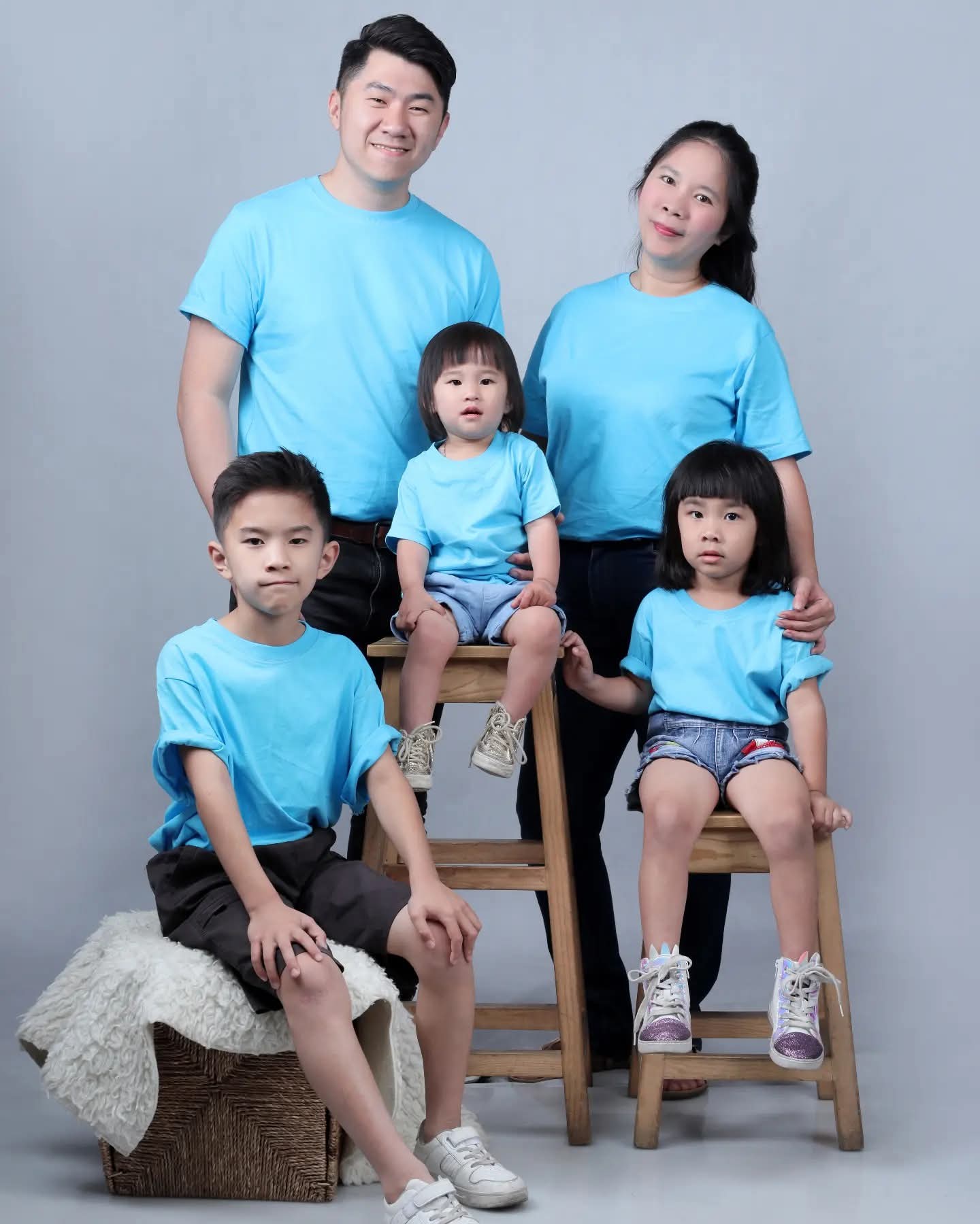 A family of five smiling to camera