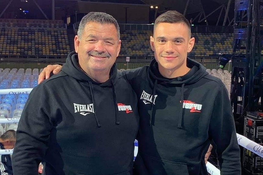 Glen Jennings, left, stands with Tim Tszyu, who has his arm around him, inside a stadium