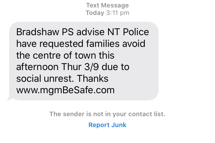 A text from a school advising families to avoid the centre of Alice Springs.