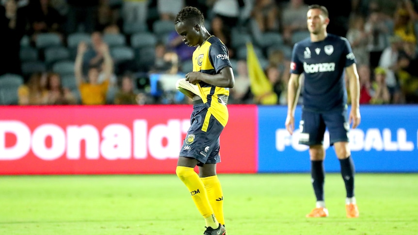 A Central Coast Mariners A-League Men player walks off the field.