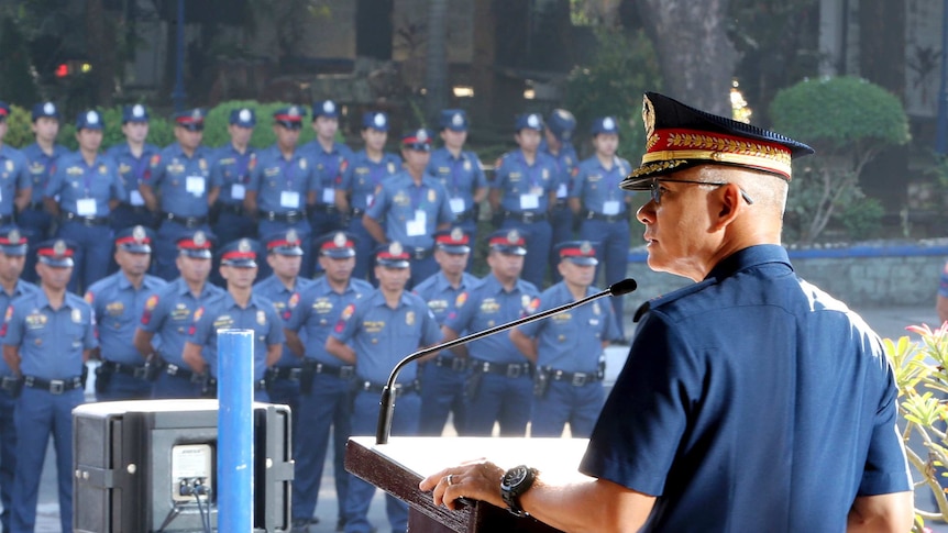 General Oscar Albayalde addresses hundreds of police officers during a flag-raising ceremony