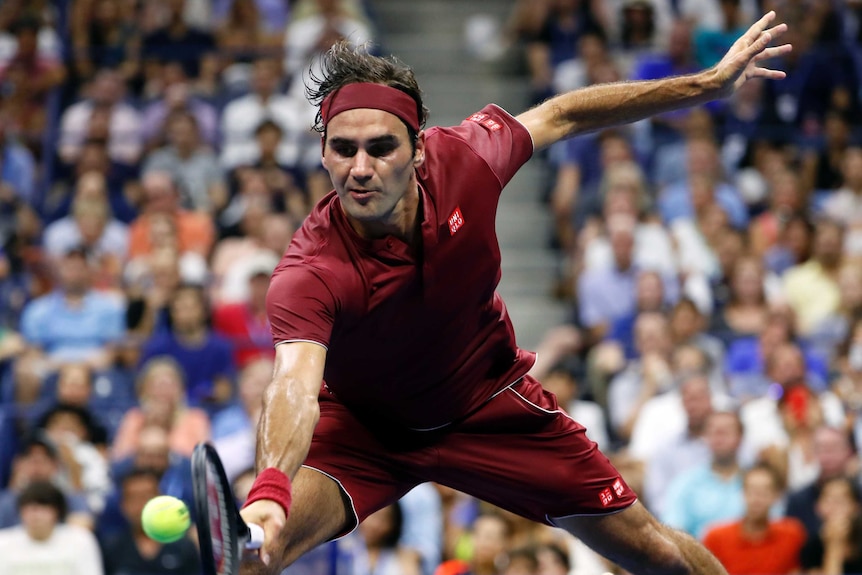 Roger Federer returns a shot to Yoshihito Nishioka in the first round of the US Open.