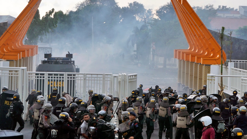 A crowd tear gassed trying to enter a stadium.