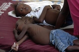 Children suffering from cholera wait for medical treatment at a local hospital