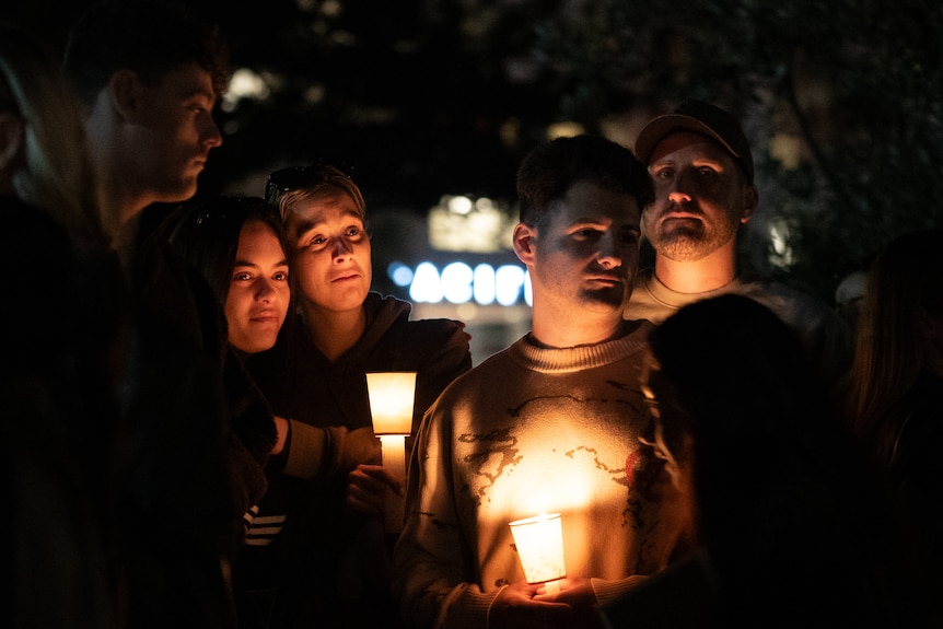 two emotional young women hug at the bondi beach vigil 210424