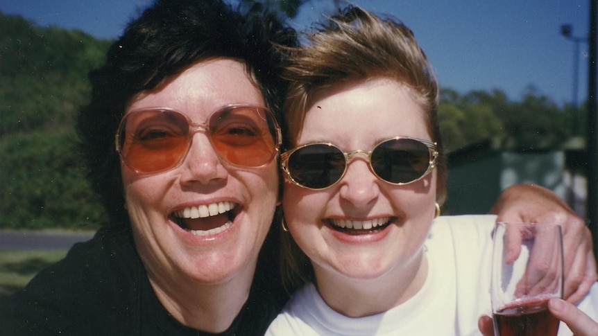 two women's faces smiling