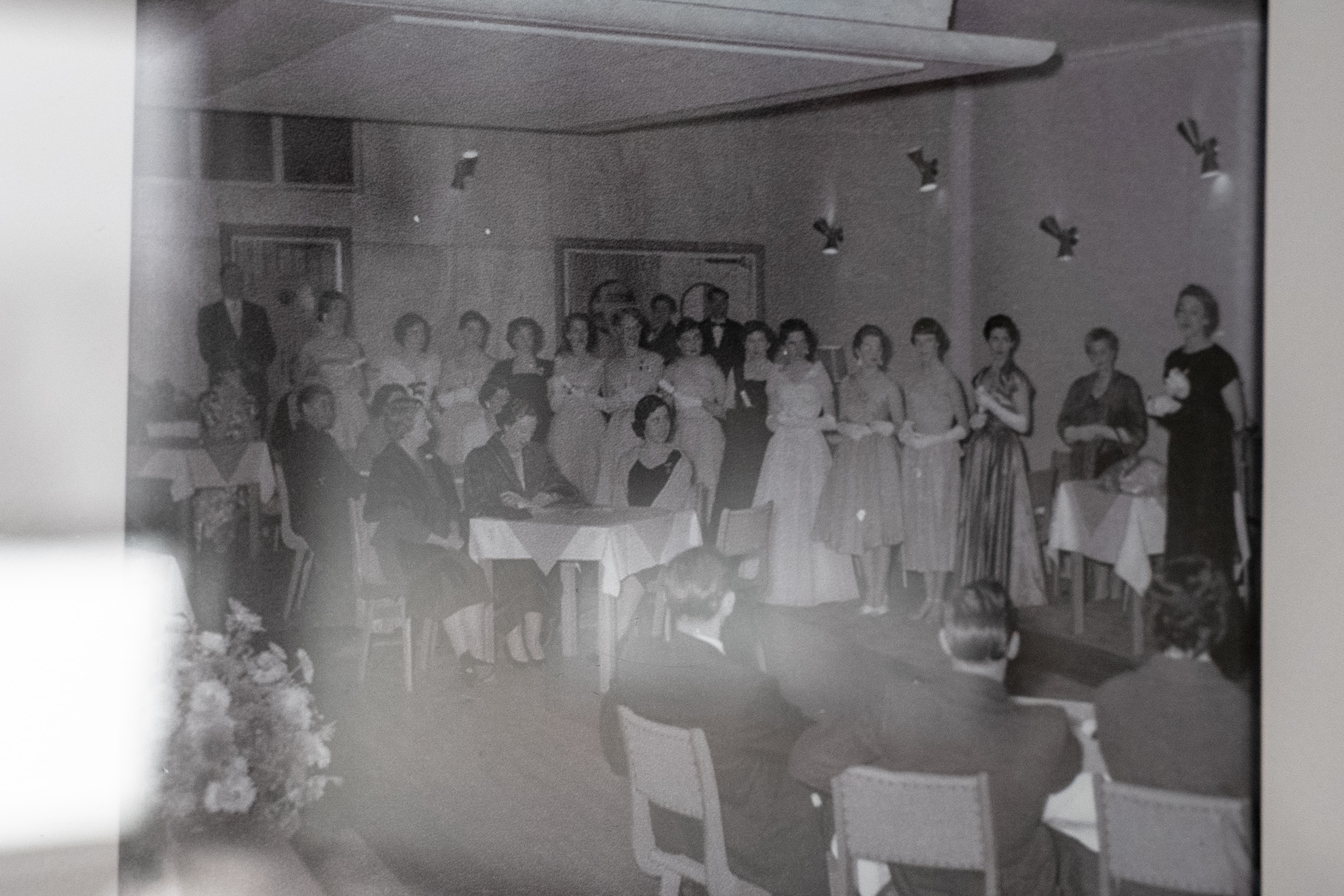A black and white photo in a frame showing female dancers standing in a room