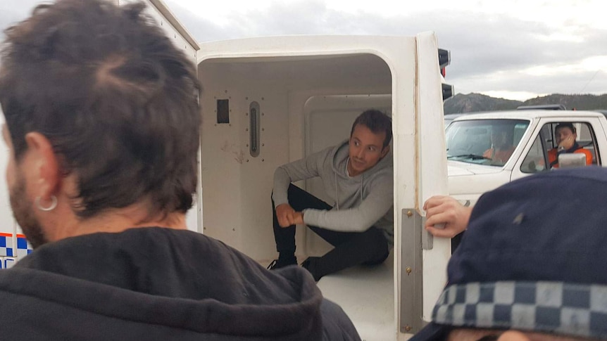 French journalist Hugo Clement in back of police van after arrest at a protest outside Abbot Point coal terminal near Bowen.