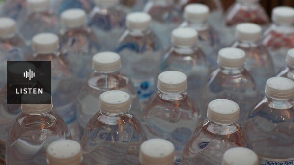 Above view of several plastic bottles of water with white lid. Has Audio.