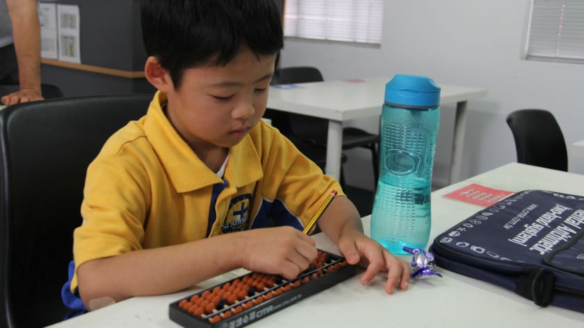 Six-year-old Anthony Hua uses the abacus to solve maths problems. 
