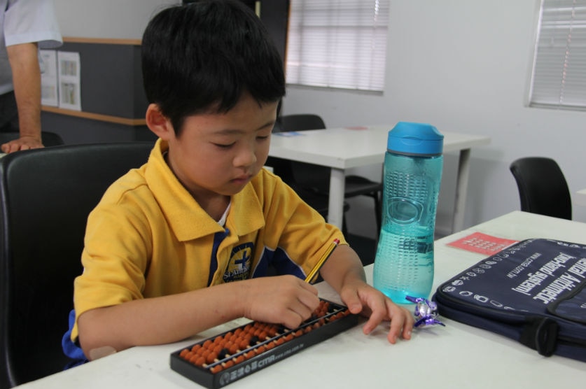 Six-year-old Anthony Hua uses the abacus to solve maths problems. 