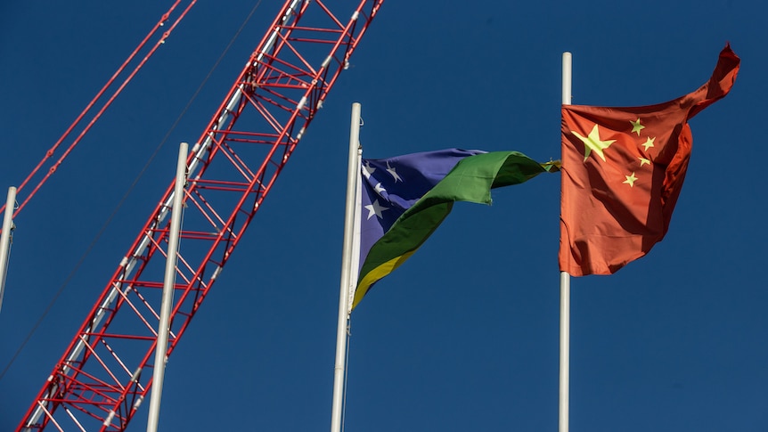 The Chinese and Solomon Islands flags flying near the stadium project.