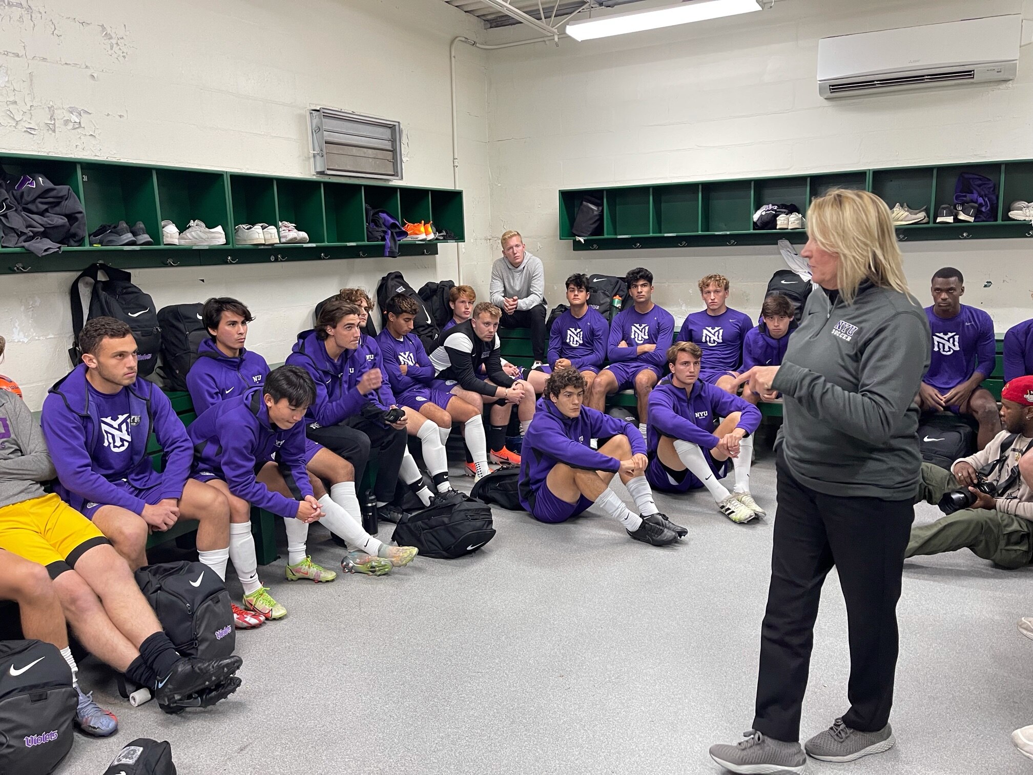 A woman soccer coach talks to her team before a game