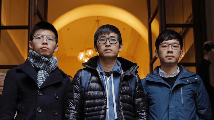 From left, Joshua Wong, Alex Chow and Nathan Law walk free from court.
