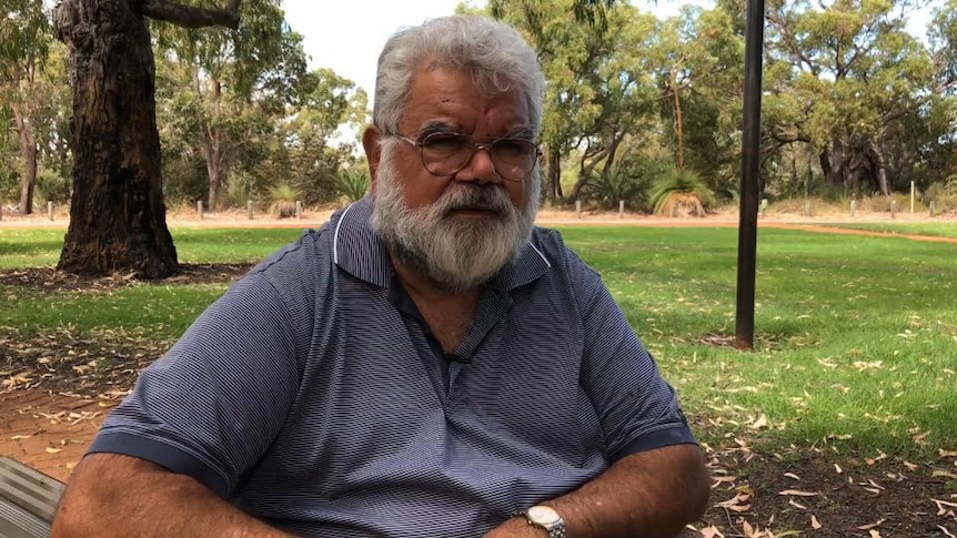 Aboriginal man sits in park