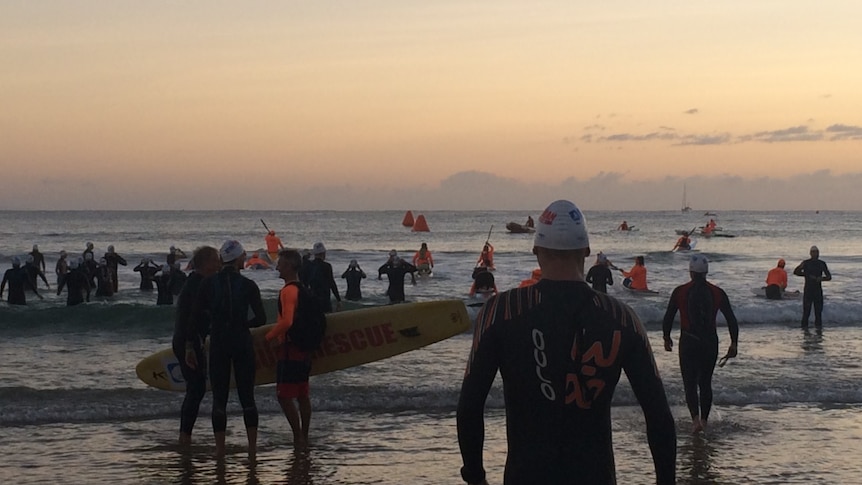 Competitors prepare to enter the water for their 10-kilometre swim at Noosa