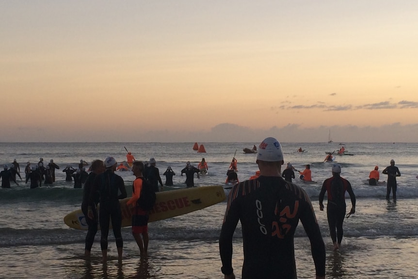 Competitors prepare to enter the water for their 10-kilometre swim at Noosa