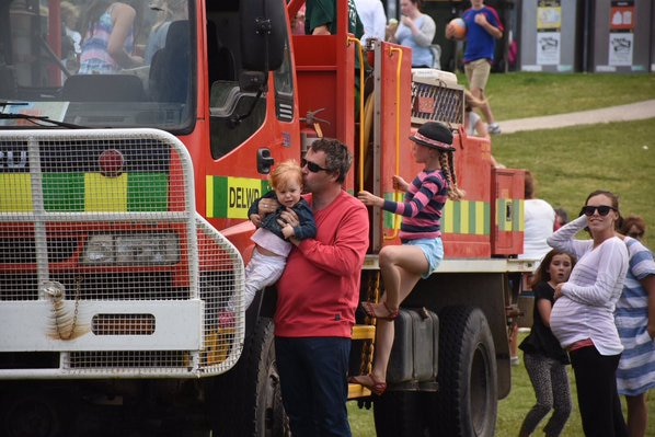 Children play on fire trucks