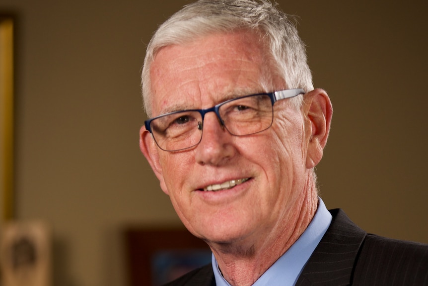 A man in a suit with grey hair