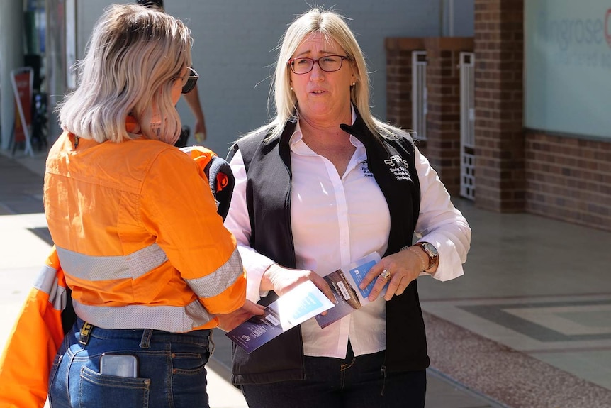 Two ladies in the street talking about road safety