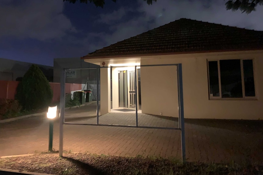 A house converted into an office with a signboard in front with no sign