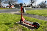 orange e-scooter propped on corner of street in Ballarat CBD 