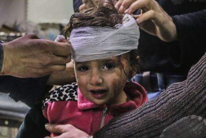 A little girl has head bandages applied