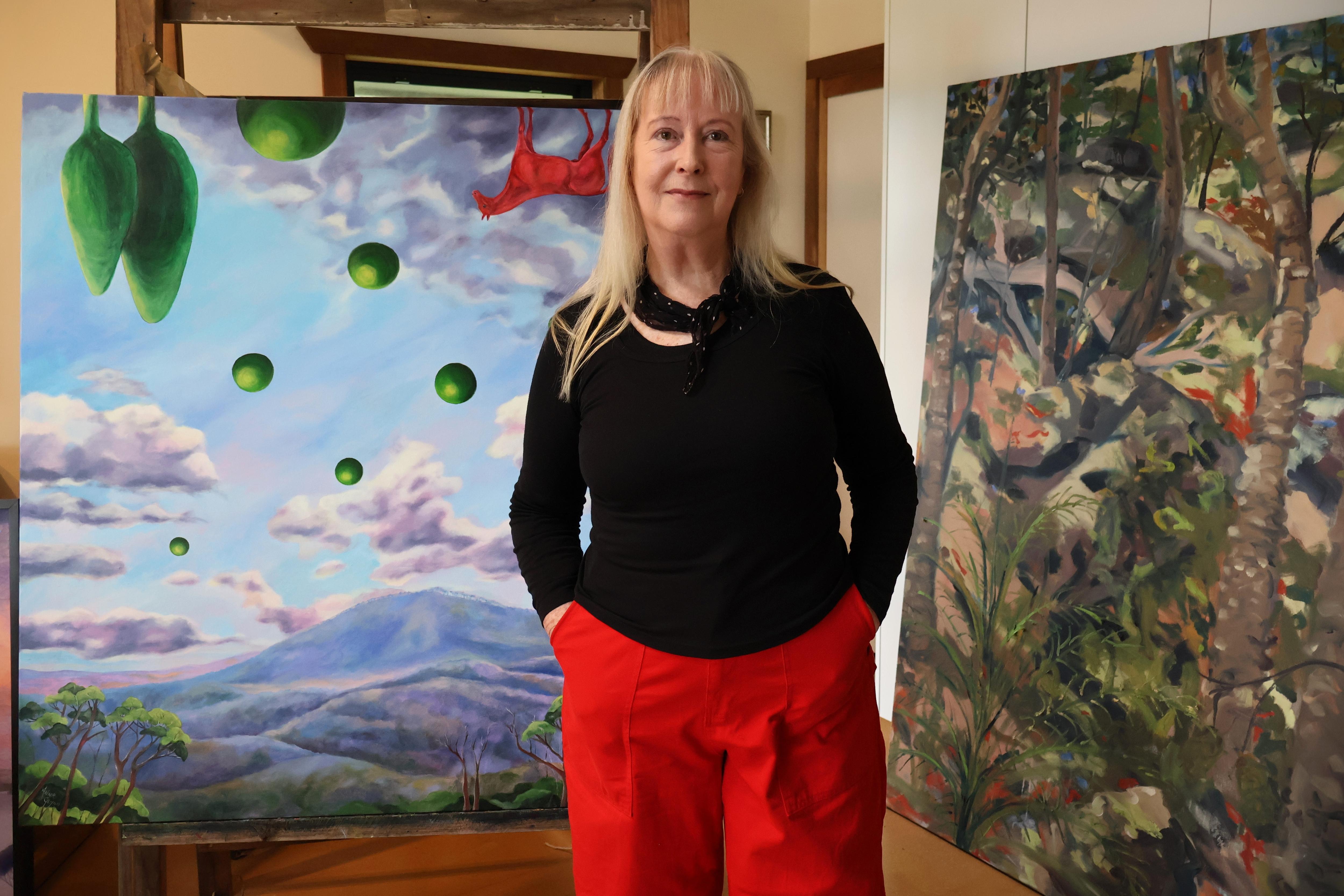 woman standing in front of artwork
