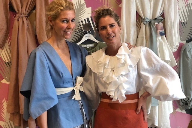 Fashion designers Sarah-Jane Clarke and Heidi Middleton pose together in their store.