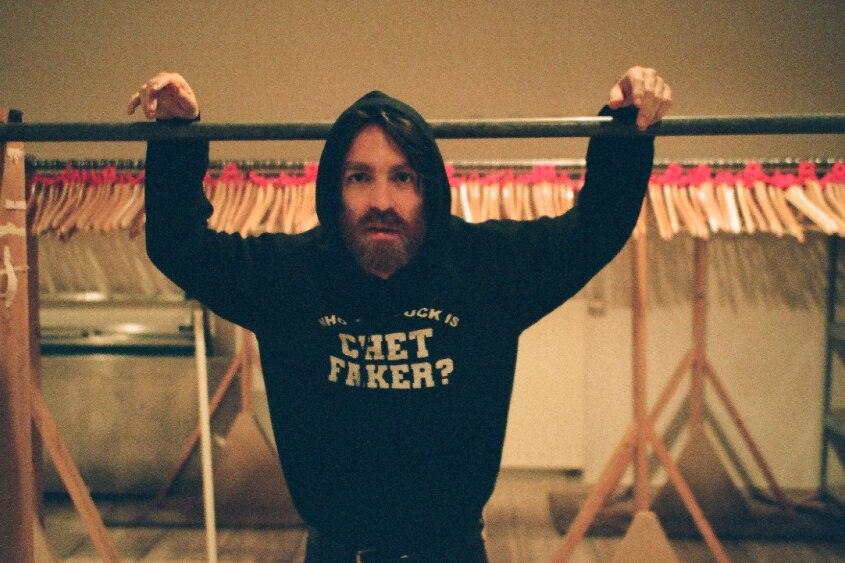 Press shot of Chet Faker, wearing hoodie with his own name